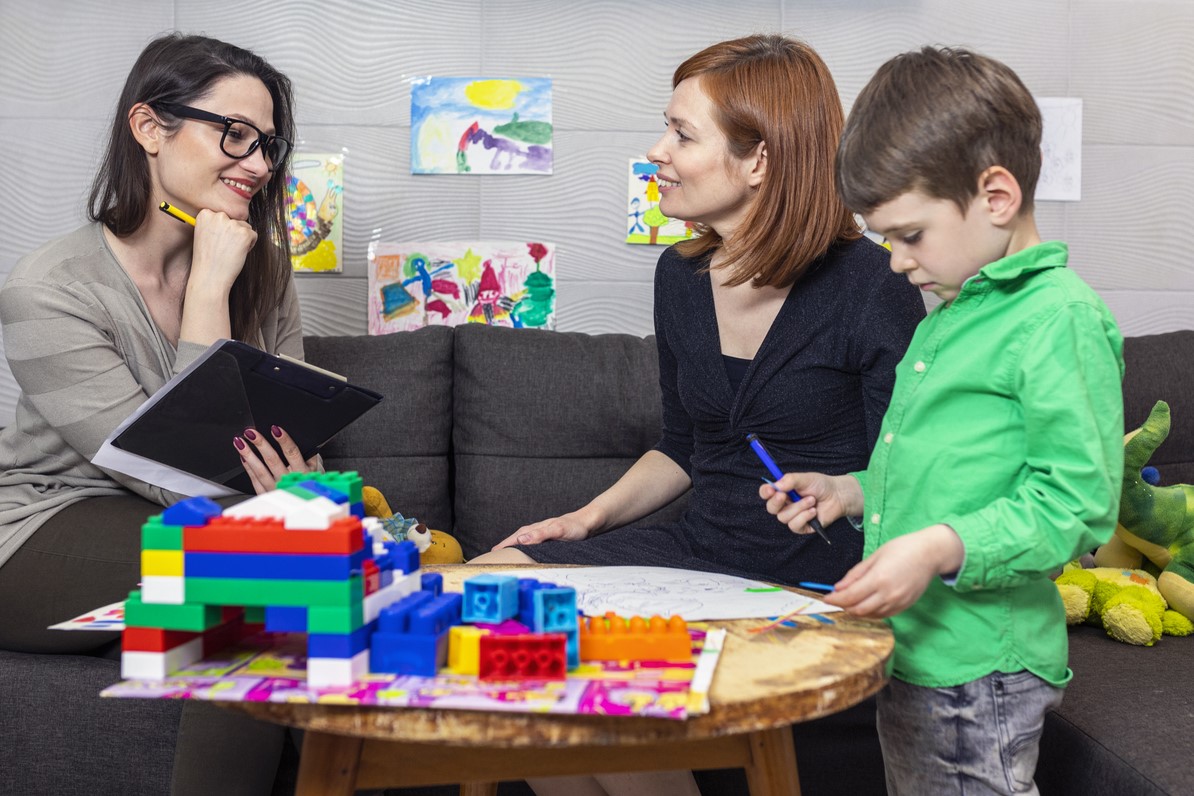young boy doing play therapy.