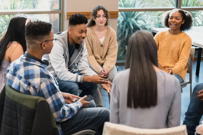 group of teens doing therapy together.