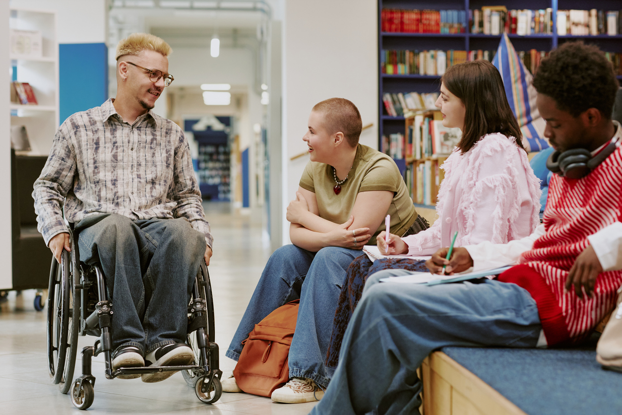 man with a disability talking with friends.